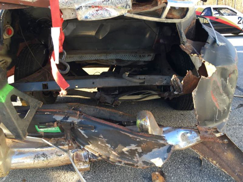 Rear of the Nash after being towed back to the paddock. The right lower trailing arm was crushed, and the transverse leaf spring and differential cover were broken. 5/8" bolts on the transmission crossmember were also sheared off on impact. Photo credit: Ron Vickers